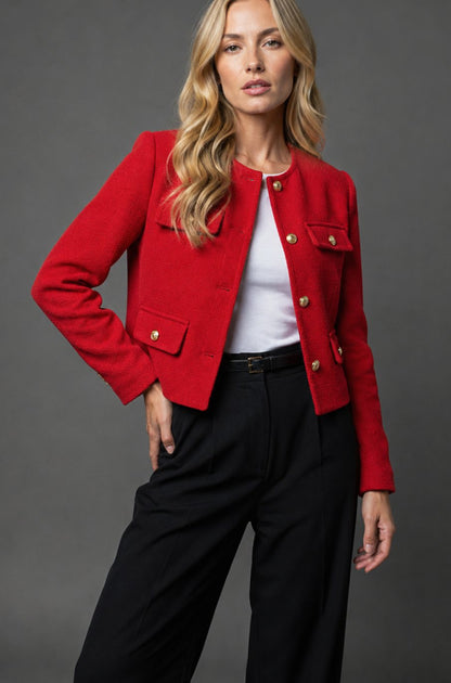 Women's cropped tweed blazer jacket by Homixa with gold buttons and flap pockets, shown on a model.