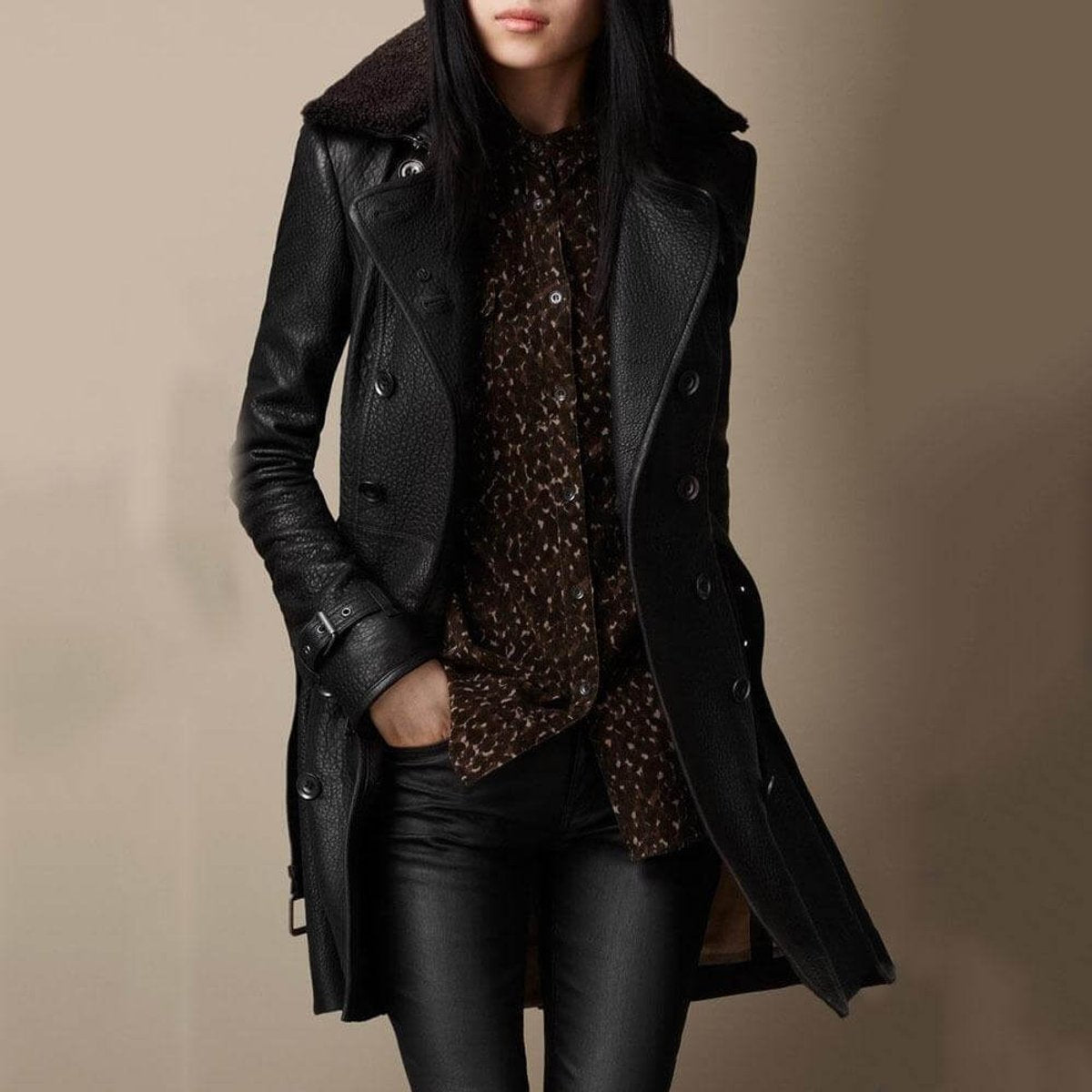 Women's double-breasted 3/4-length leather jacket with shearling collar by Homixa, shown on a model.