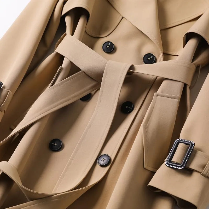 Women's Homixa double-breasted trench coat with belt, buckled cuffs, and plaid lining, displayed on a model.