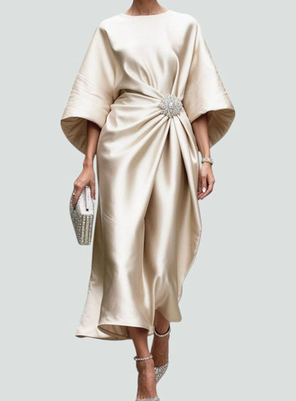 Women's satin midi dress with draped design, batwing sleeves, and brooch detail by Homixa.