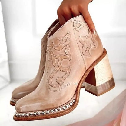 Women's embroidered cowboy boots by Homixa with a block heel and decorative studded welt, showcasing detailed stitching and stylish design.