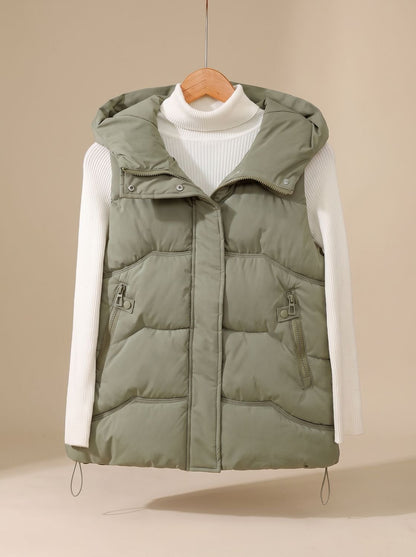 Women’s Homixa hooded padded puffer vest for fall and winter with zipper pockets, featuring a quilted design and cozy hood.