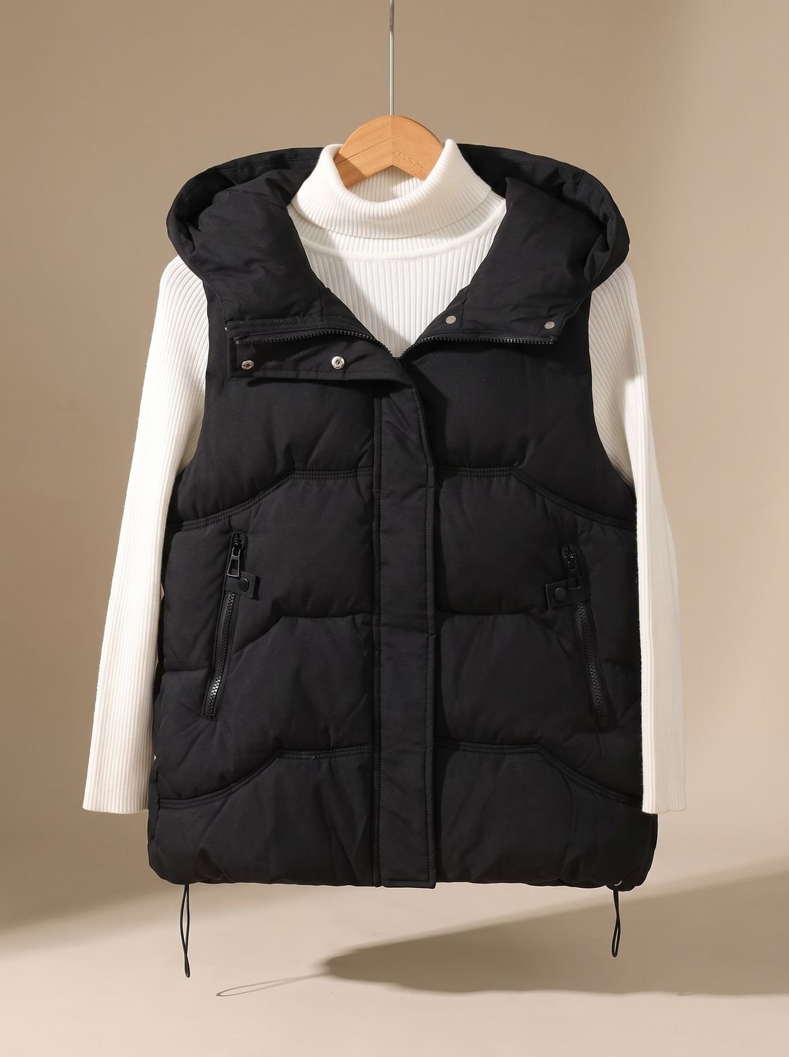 Women's Homixa padded hooded puffer vest with zippered pockets, suitable for fall and winter, featuring a cozy, insulated design