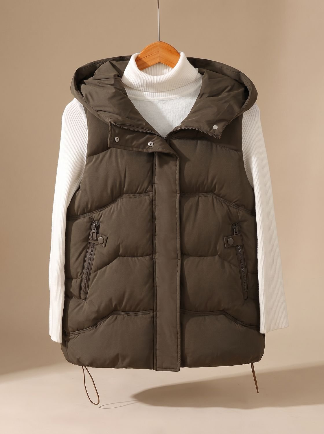 Women's Homixa hooded puffer vest with padding and zippered pockets, ideal for fall and winter layering.