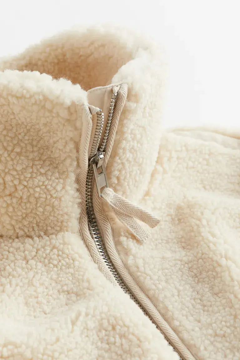 Women’s Homixa faux-fur fleece jacket with high collar, zip front, and patch pockets, shown on a model.