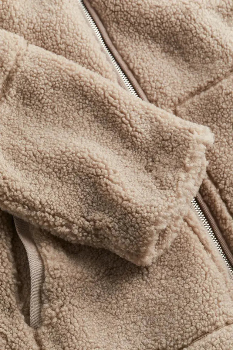 Women's faux-fur fleece jacket by Homixa featuring a high collar, zip front, and patch pockets in a cozy, stylish design.