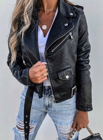 Women's faux leather biker jacket by Homixa featuring a diagonal zip front and belt detail, styled with a classic biker silhouette.