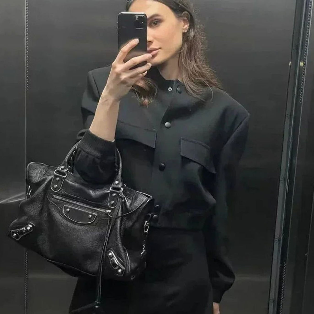 Women's faux-leather bomber jacket by Homixa featuring snap buttons, patch pockets, and a ribbed collar.