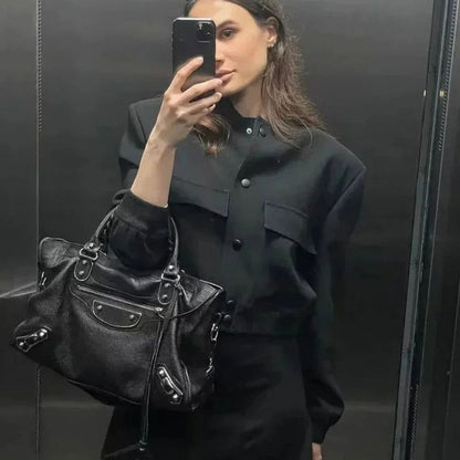 Women's faux-leather bomber jacket by Homixa featuring snap buttons, patch pockets, and a ribbed collar.