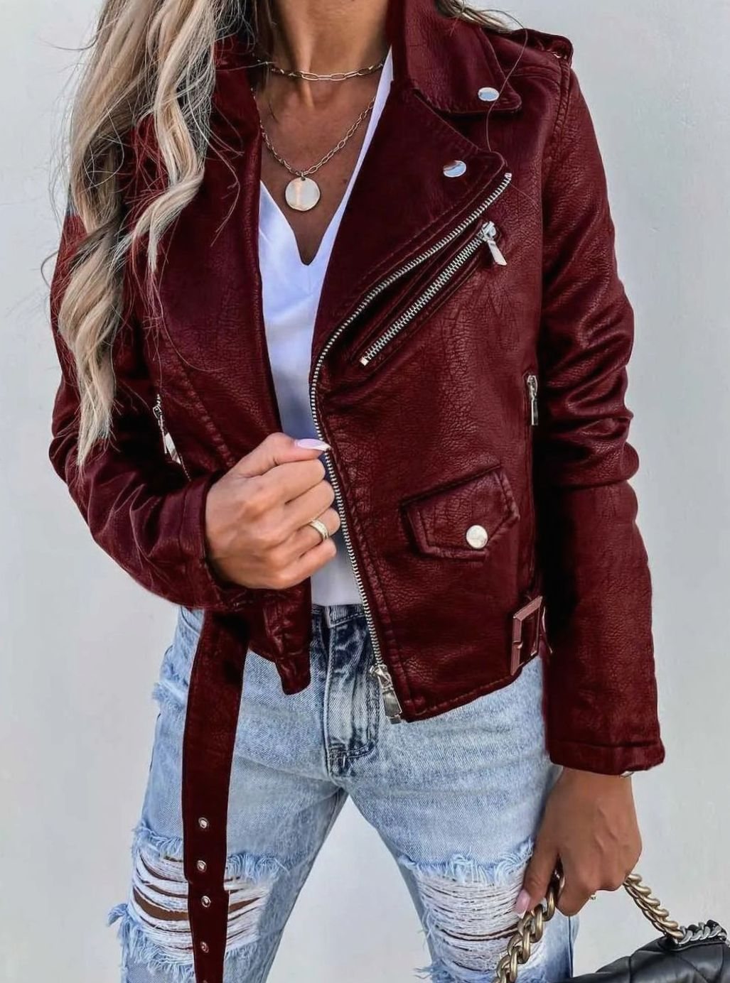 Women's fitted faux-leather biker jacket by Homixa featuring an asymmetric zip, belted waist, and stylish moto design.