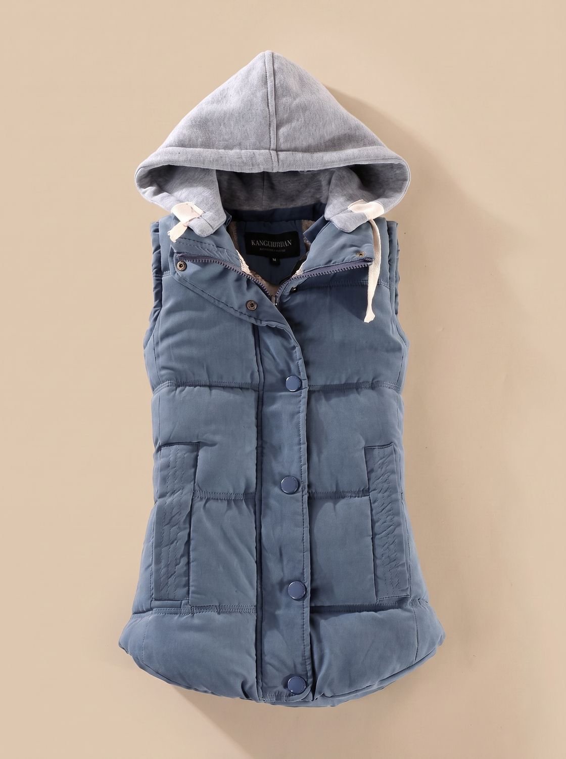 Women's Homixa fitted puffer vest with quilted fill and a detachable contrast hood, showcasing its stylish and warm design.