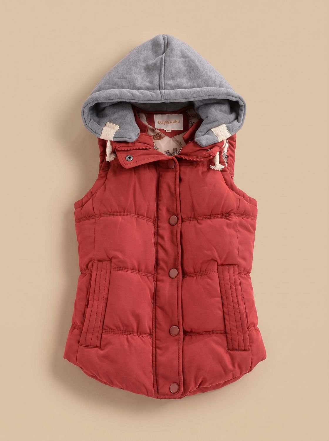 Women's fitted puffer vest by Homixa with quilted fill and a detachable contrast hood, showcasing the stylish hooded outerwear.