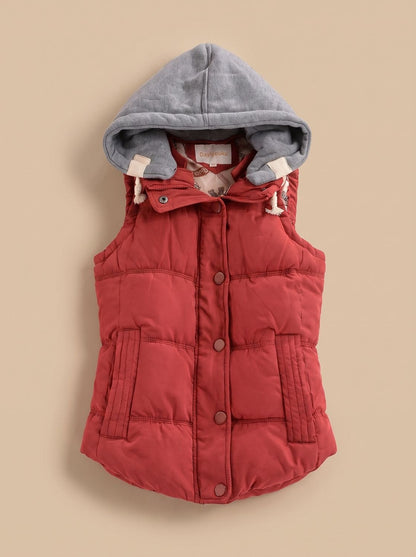 Women's fitted puffer vest by Homixa with quilted fill and a detachable contrast hood, showcasing the stylish hooded outerwear.