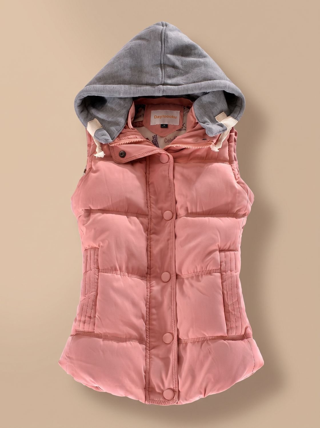 Women's fitted puffer vest with quilted fill and detachable contrast hood by Homixa, showing the vest's front view and hood details.