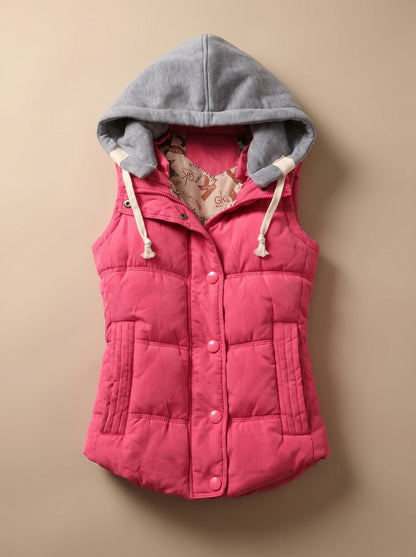 Women's Homixa fitted puffer vest with quilted fill and detachable contrast hood, shown on a model with front view.