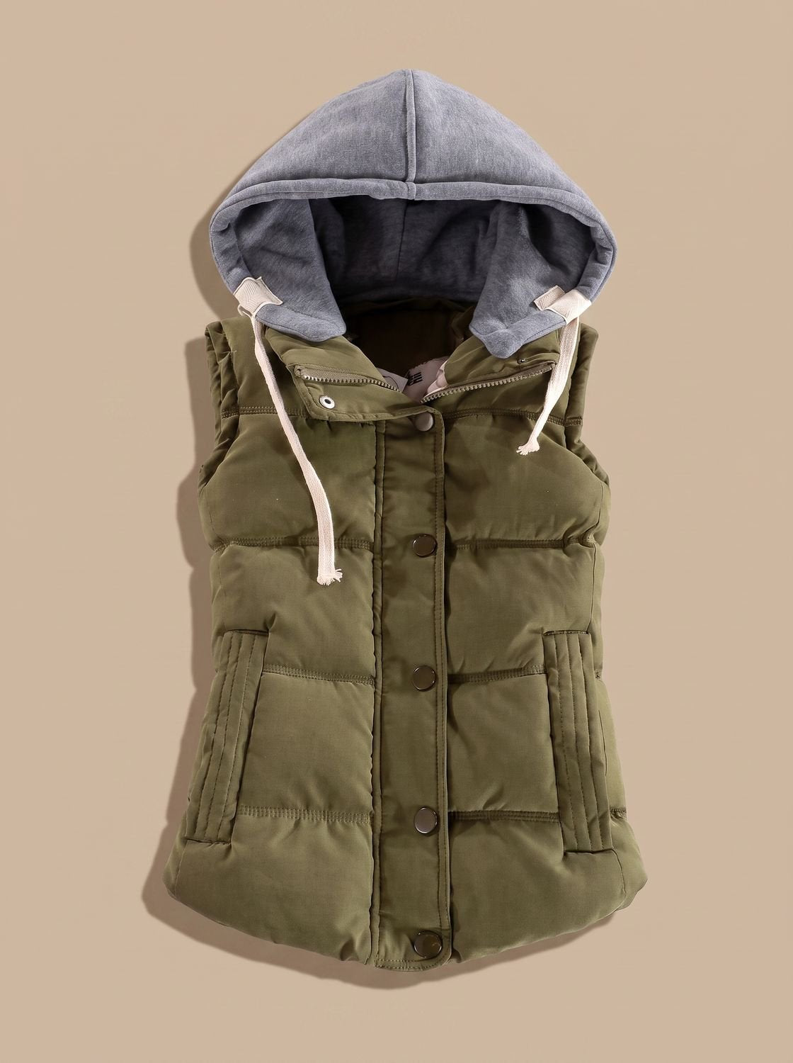 Women's fitted puffer vest by Homixa with quilted fill and a detachable contrast hood, shown on a model.