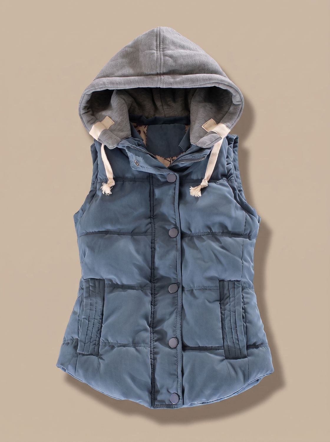 Women’s fitted puffer vest with quilted fill and detachable contrast hood by Homixa, shown on a mannequin.