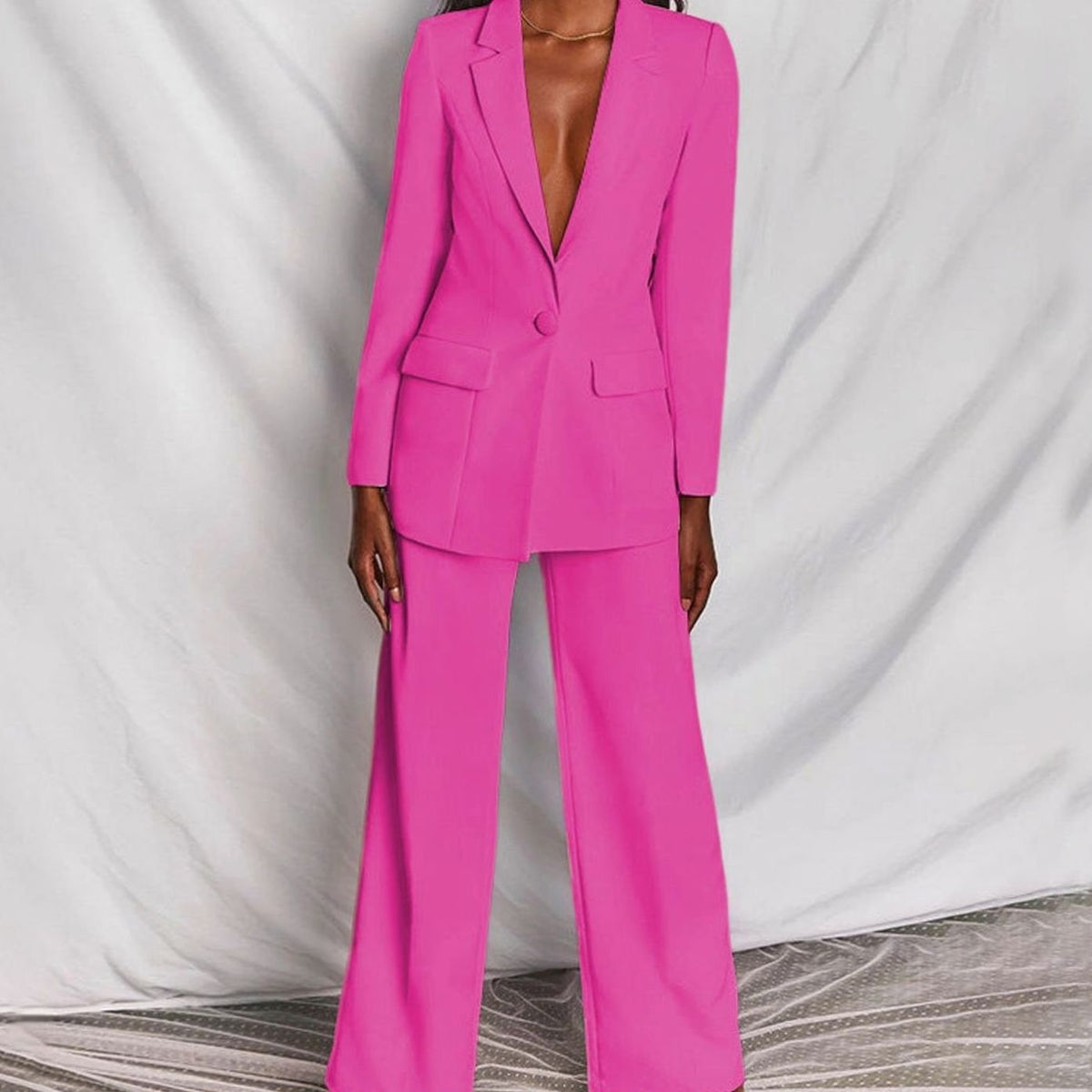 Women's fitted tailored pantsuit by Homixa featuring a one-button blazer and wide-leg pants, styled for a polished professional look.