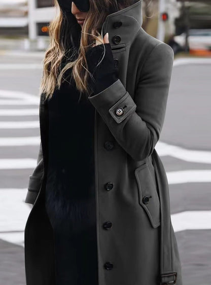 Women's fitted winter coat by Homixa with high collar, button front, and side pockets, tailored for a sleek, warm fit.