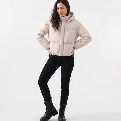 Women's Homixa cropped puffer jacket with hood, full zip, boxy fit, and quilted shell, displayed on a hanger.