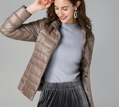 Women's Quilted Winter Jacket by Homixa featuring full-zip closure, slim fit, and stand collar for cold weather warmth.