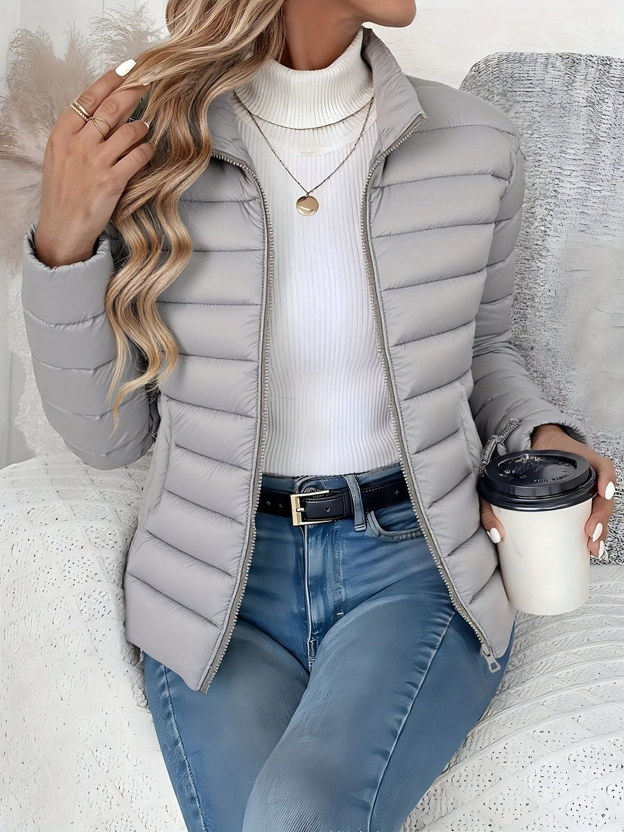 Women's Homixa quilted winter jacket with full zip, slim fit, and stand collar, designed for warmth and style.