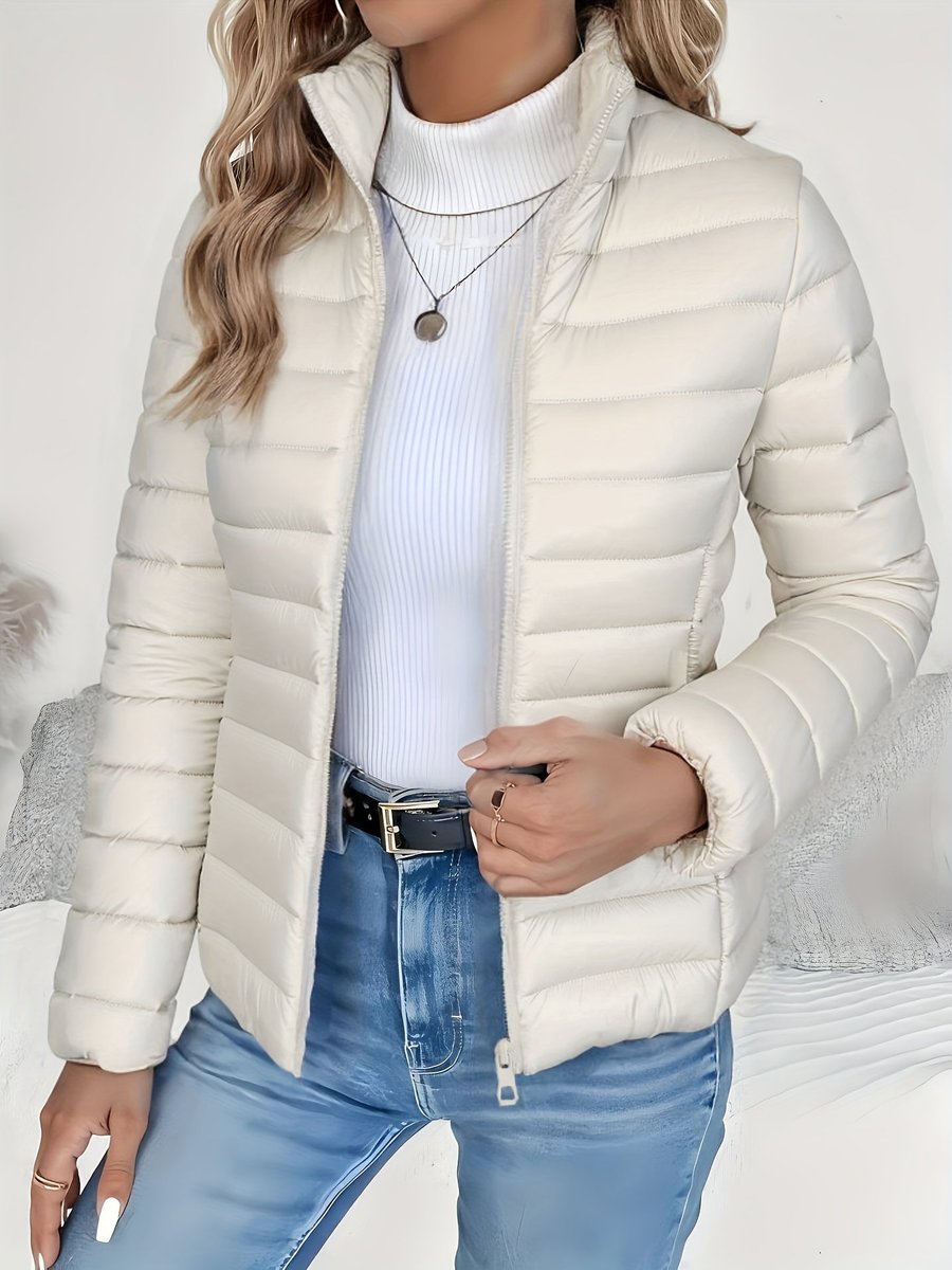Women's full-zip quilted winter jacket by Homixa with slim fit and stand collar, showcasing the stylish and warm outerwear design.