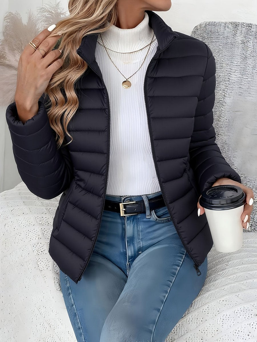 Women's quilted winter jacket with full zip, slim fit, and stand collar by Homixa, shown on a model.