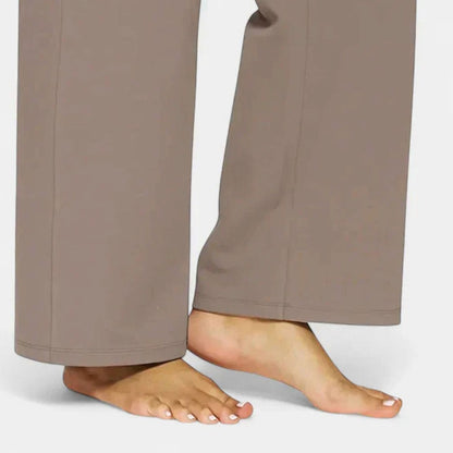 Homixa women's high-waist wide-leg trousers with elastic waistband and deep side pockets, shown in a stylish relaxed fit.