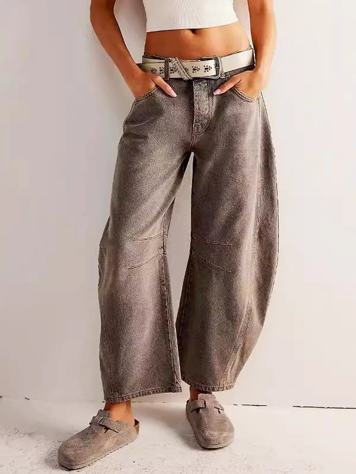Women's high-waisted wide-leg jeans by Homixa with belt loops, front pockets, and a relaxed fit, styled on a model.