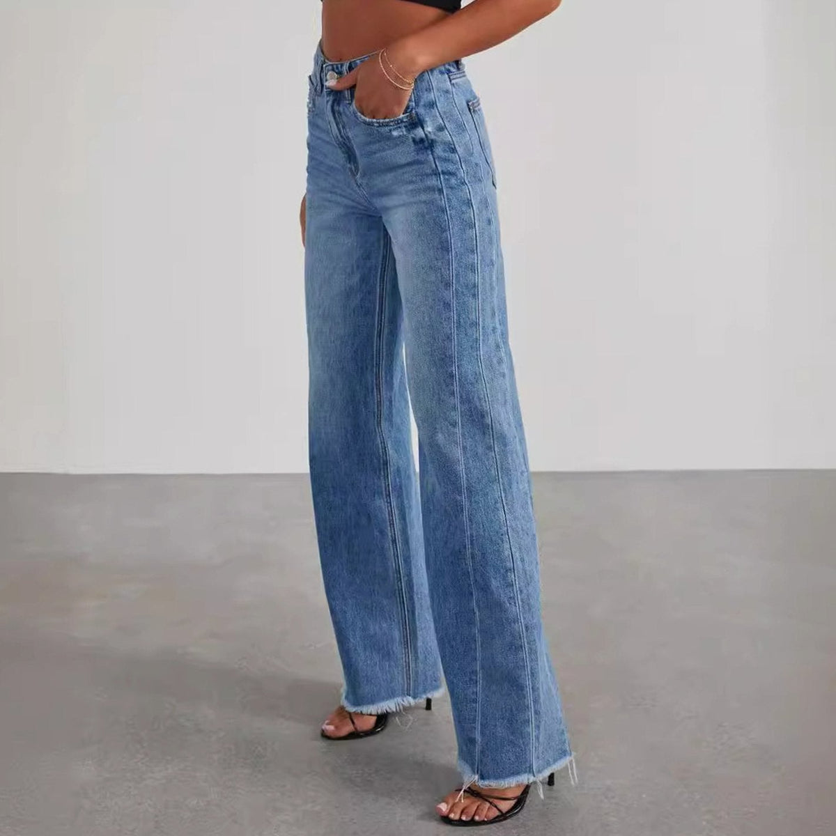 Women's high-waisted wide-leg jeans by Homixa featuring denim fabric and raw frayed hem, front view showcasing relaxed fit.