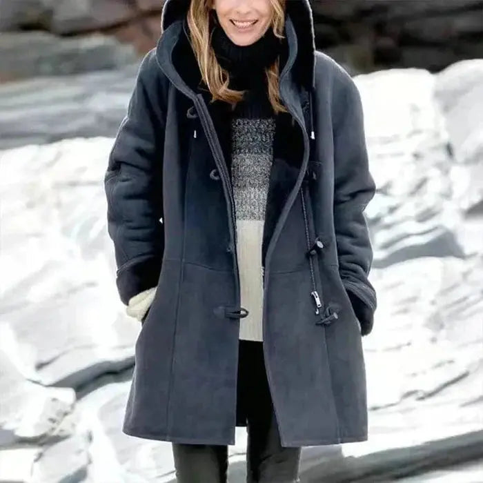 Women's fleece-lined coat by Homixa featuring a hood, tailored fit, and room for layering, ideal for cold weather.