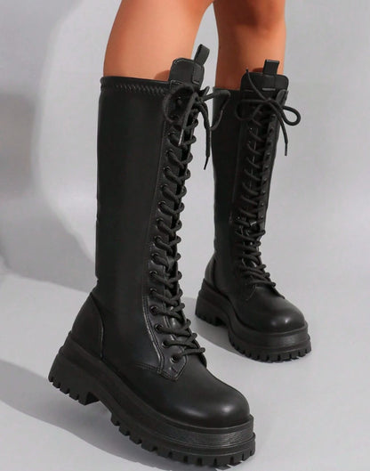 Women's knee-high faux leather boots by Homixa featuring a chunky sole and side zip closure, stylish and comfortable footwear.