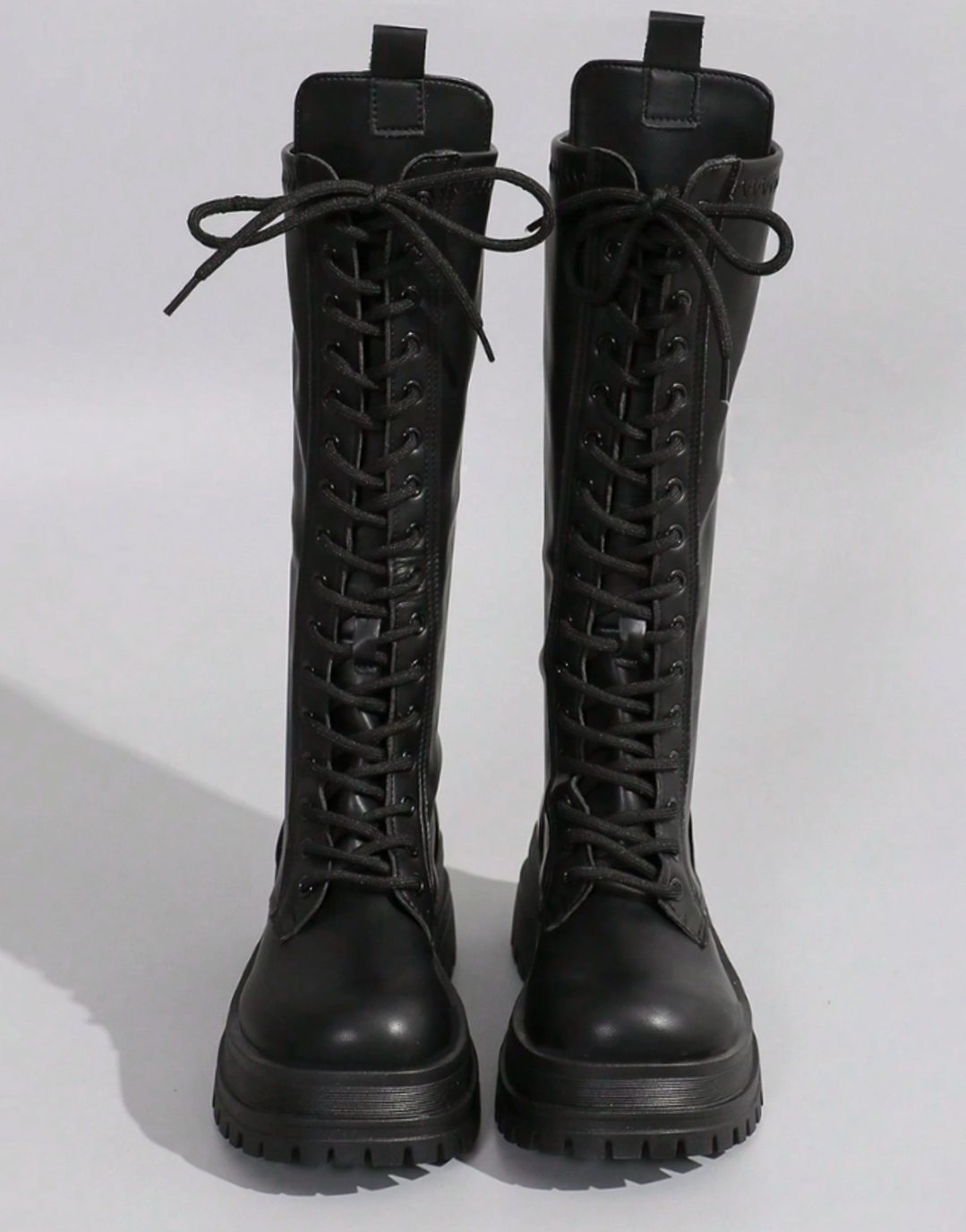 Women's knee-high faux leather boots by Homixa with chunky sole and side zipper, stylish and durable footwear.
