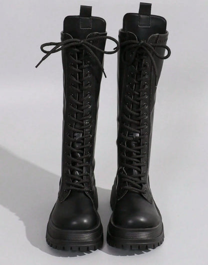 Women's knee-high faux leather boots by Homixa with chunky sole and side zipper, stylish and durable footwear.