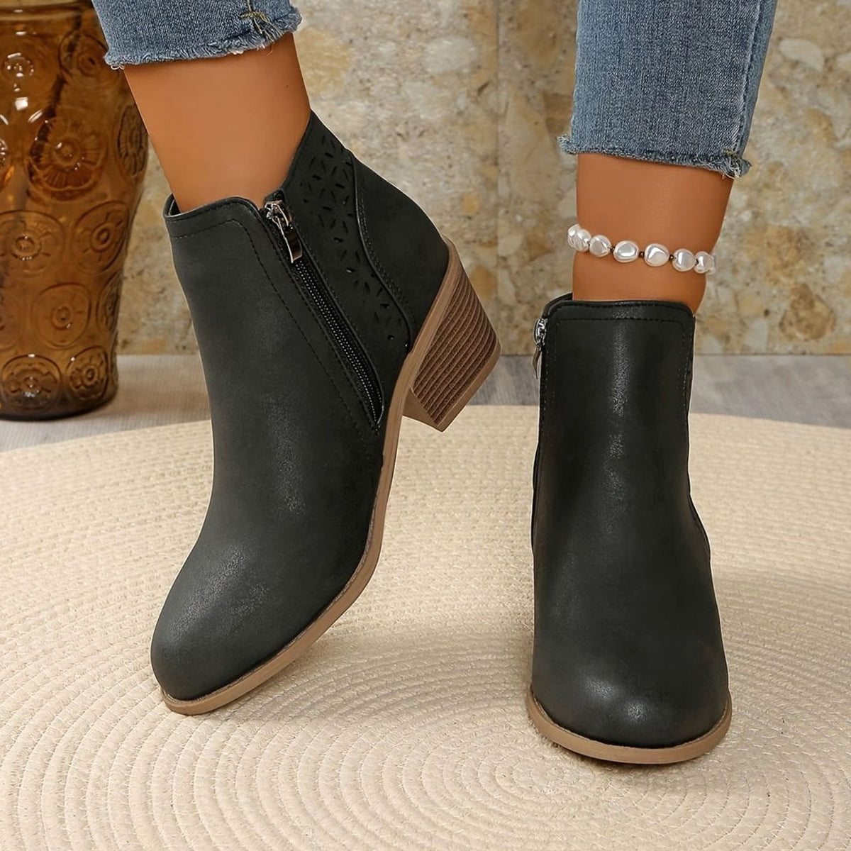 Women's Homixa laser-cut booties with floral cutout design, block heel, and side zipper for stylish comfort.