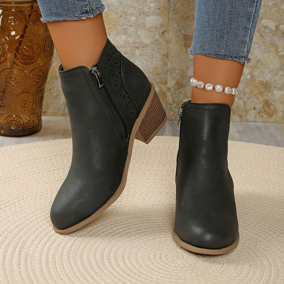Women's laser-cut booties with floral cutout design, block heel, and side zipper from Homixa.