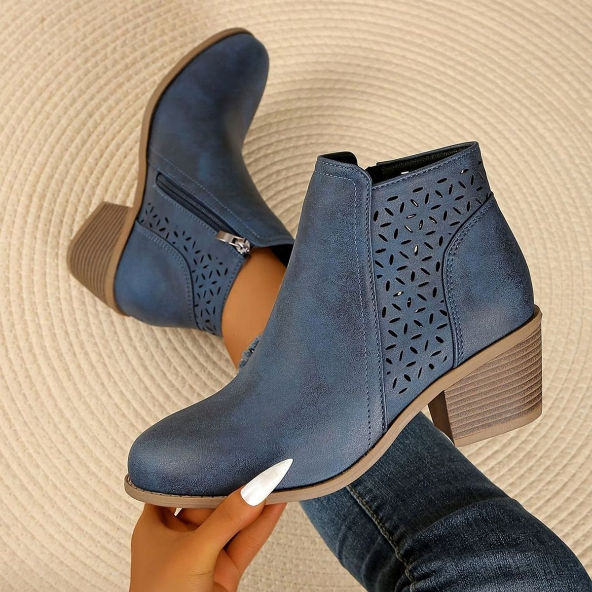 Women's Homixa laser-cut booties with floral cutout design, block heel, and side zipper for stylish comfort.