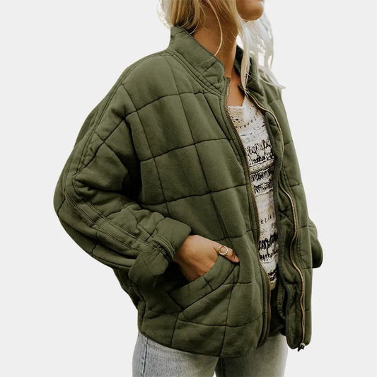 Women's lightweight quilted jacket by Homixa featuring a relaxed fit and zip-front closure, shown in a stylish outdoor setting.