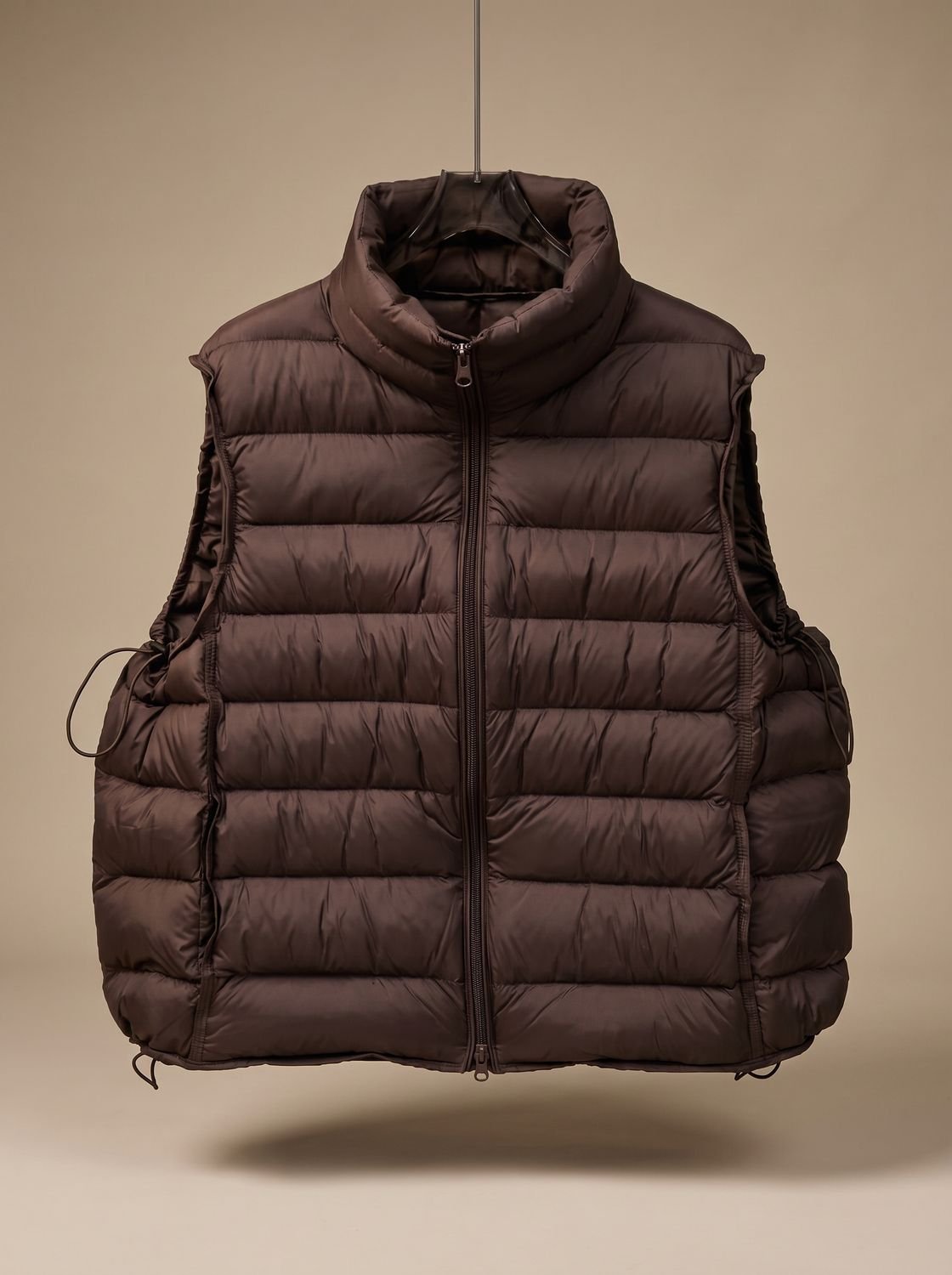 Women's lightweight sleeveless puffer vest by Homixa with stand collar and two-way zipper, shown on model in outdoor setting.