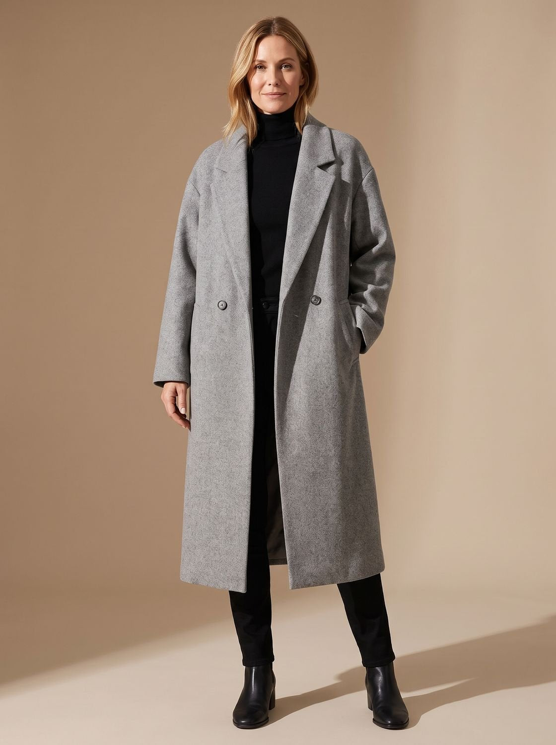 Women's long double-breasted overcoat with wide notched lapel collar by Homixa, shown hanging on a clothing rack.
