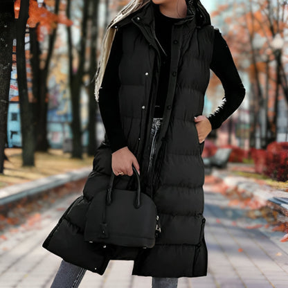 Women's long hooded puffer vest by Homixa with quilted design, side pockets, and a cinched waist, perfect for layered winter style.