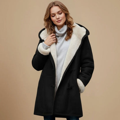 Women's long hooded winter duffle coat by Homixa with toggle buttons and a regular fit, shown on a model outdoors.
