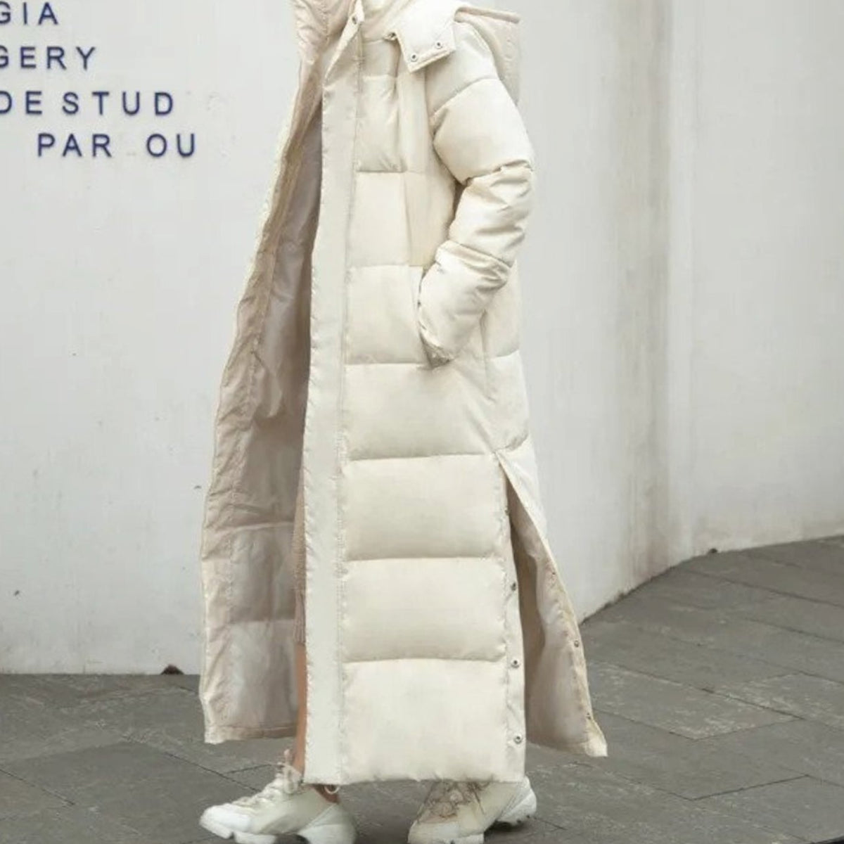 Women’s long quilted puffer winter coat with high collar, zip-up closure, and snap buttons by Homixa.
