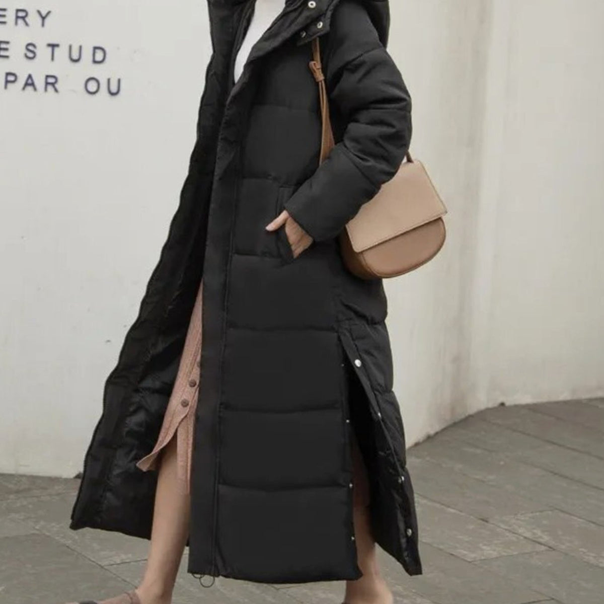 Women's long quilted winter puffer coat by Homixa with high collar, zip-up front, and snap buttons for warmth and style.