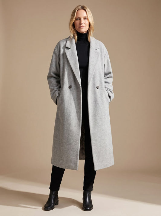 Women's long tailored wool coat by Homixa featuring lapels and a double-breasted button front, styled for a sophisticated look.