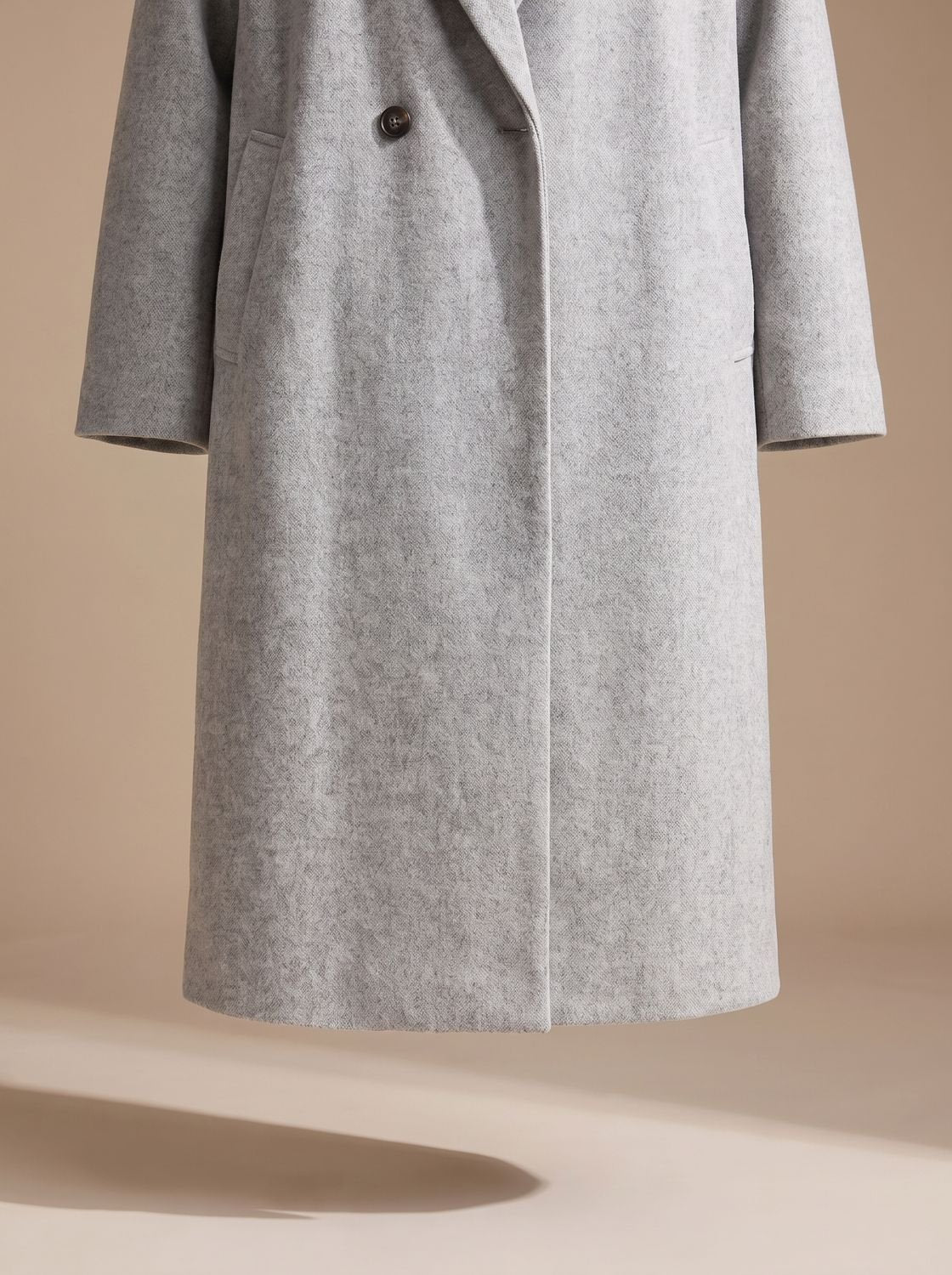 Women's tailored wool coat by Homixa featuring lapels and double-breasted buttons, shown on a model with a classic overcoat fit.