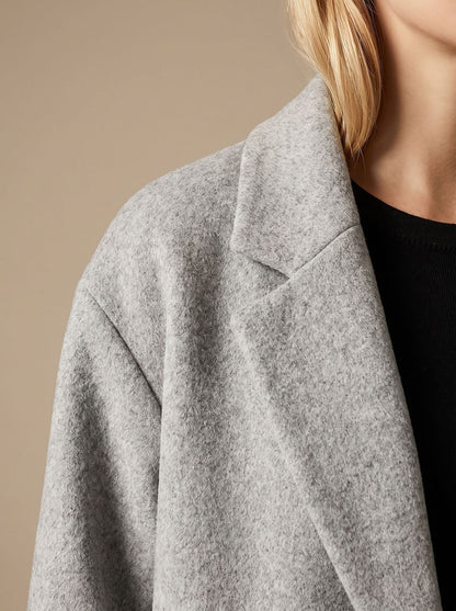 Women's tailored wool coat with lapels and double-breasted buttons, in a classic overcoat style by Homixa