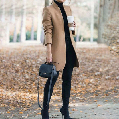 Women's longline winter jacket by Homixa with stand collar and slim, elegant silhouette for stylish winter warmth.