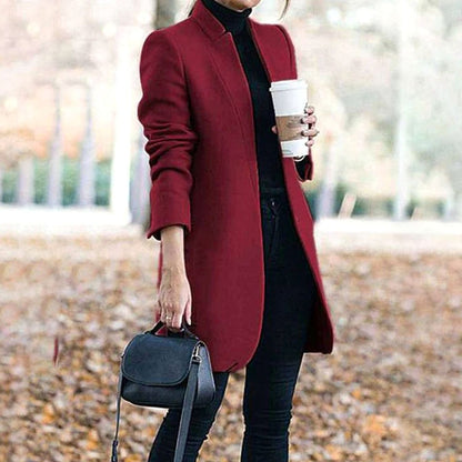 Women's longline winter jacket by Homixa with stand collar and slim, elegant silhouette, suitable for cold weather.